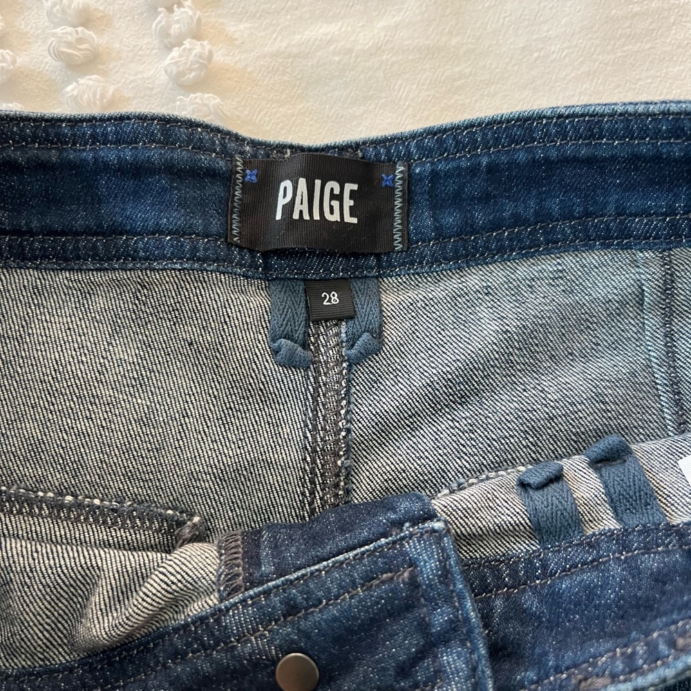 Size 28, Paige Jeans. Flared and super flattering in a crisp dark blue wash.
